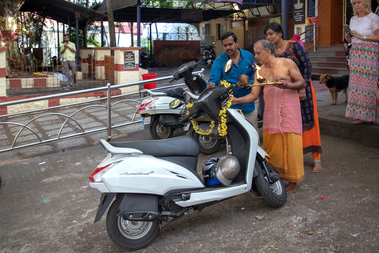 A beautiful capture in which a married couple get a priest to bless their new moped at the Bull Temple in Bangalore