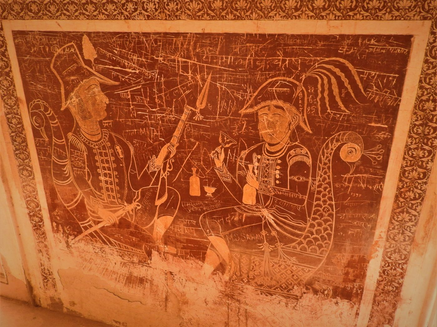 Paintings of British officers holding their guns while one of them enjoys a glass of wine, Orchha 