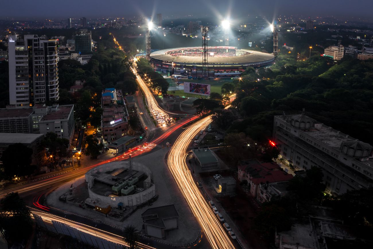 Stunning traffic light trails at night around Chinnaswamy Cricket Stadium, lighting it with glory at Bangalore
