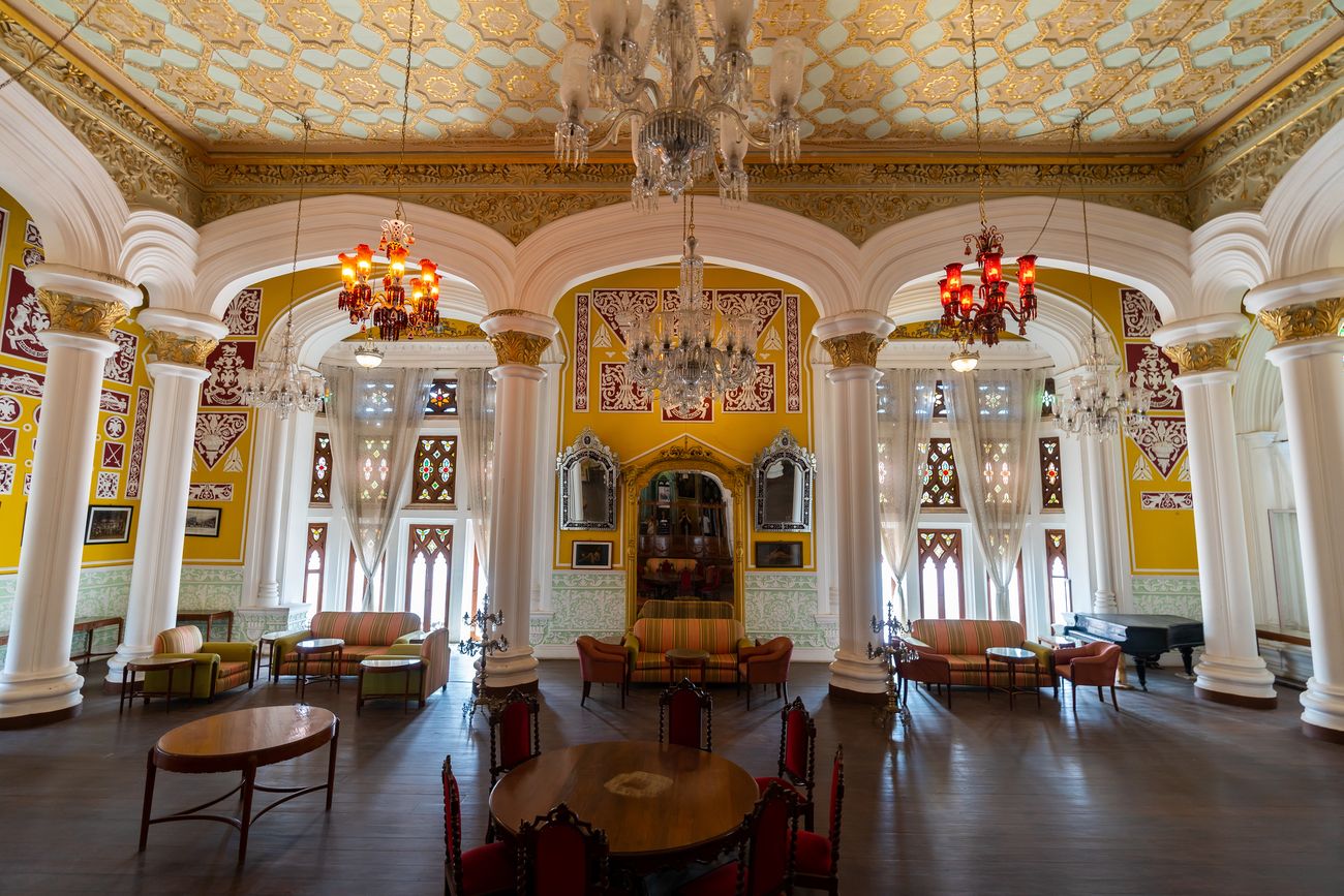 The antique interiors inside the Bangalore palace whose architectural style is a mix of Tudor and Scottish Gothic with huge chandeliers