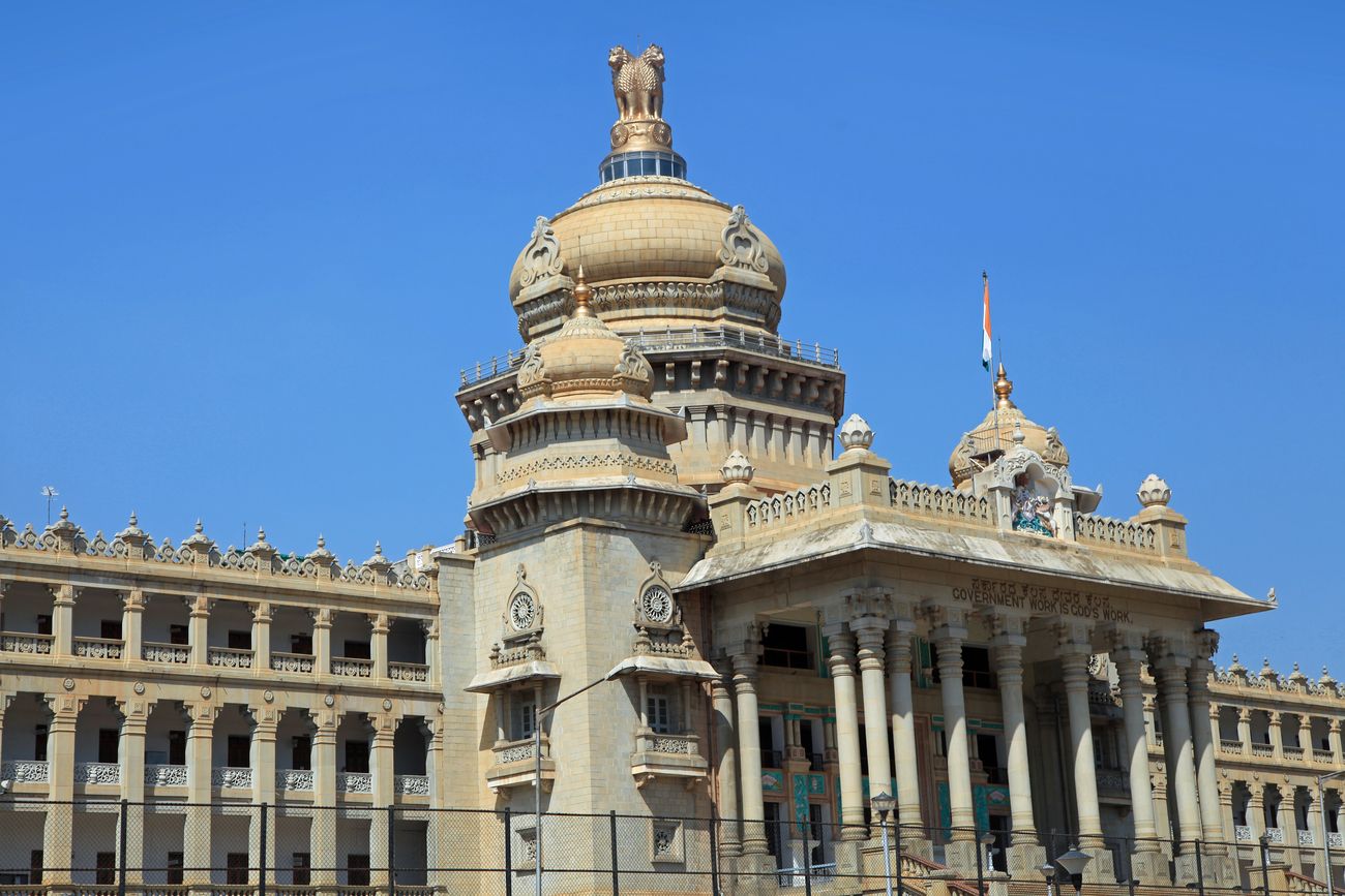 The city's most identifiable landmark, the Vidhana Soudha (Parliament house) features a granite edifice with white onion domes, massive pillars and archways. On the top of the dome is the Lion capital, the emblem of India