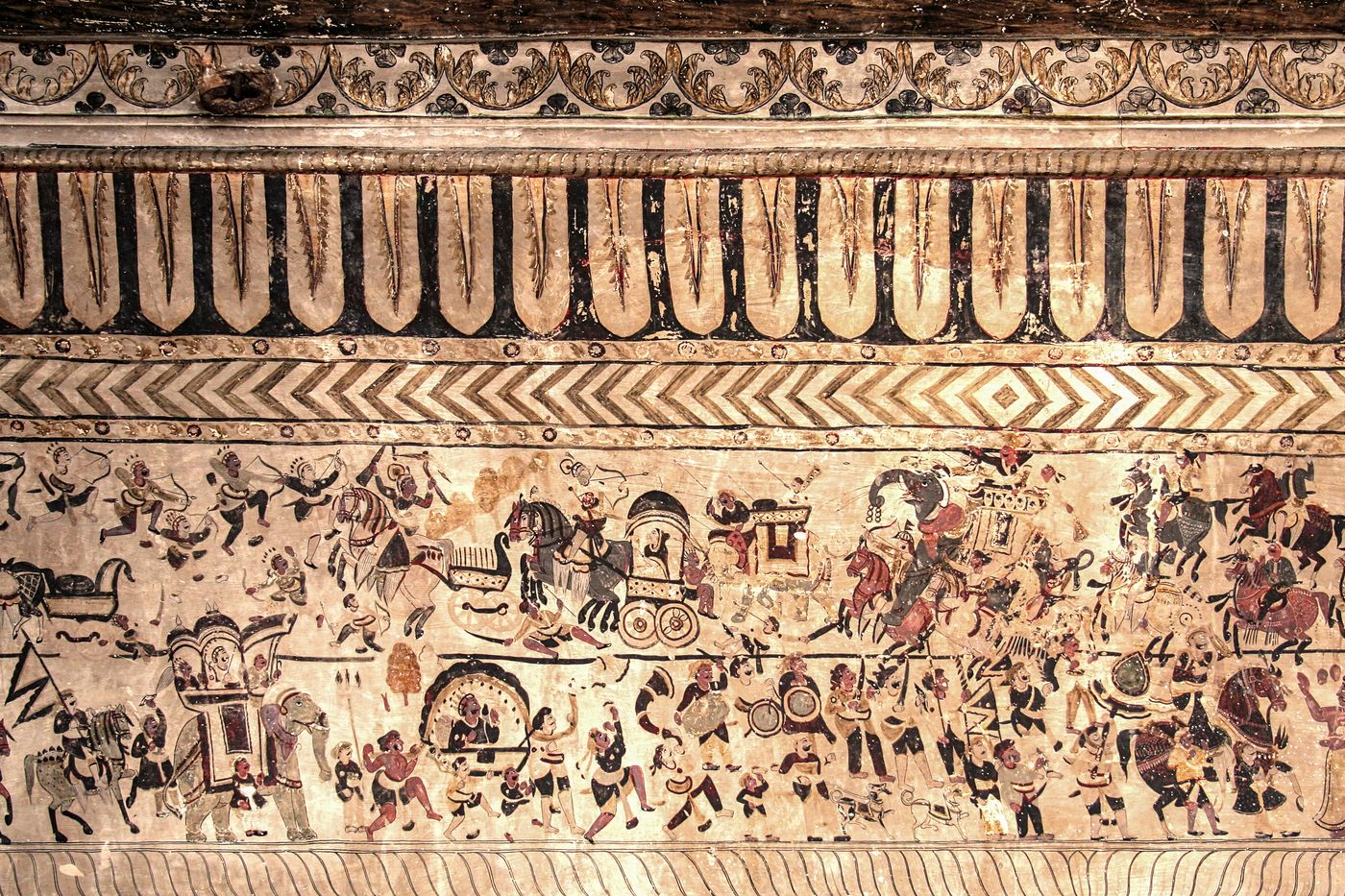 The panel below depicts a royal family wedding procession. The upper panel depicts a fighting scene, Orchha