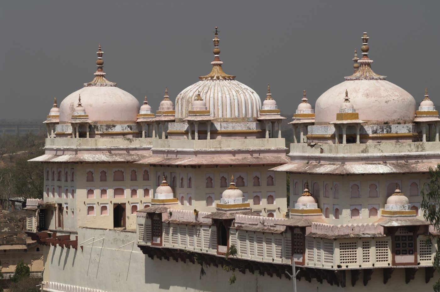 The pink and cream exterior of Ram Raja, the 17th century Hindu temple capped with domes, Orchha