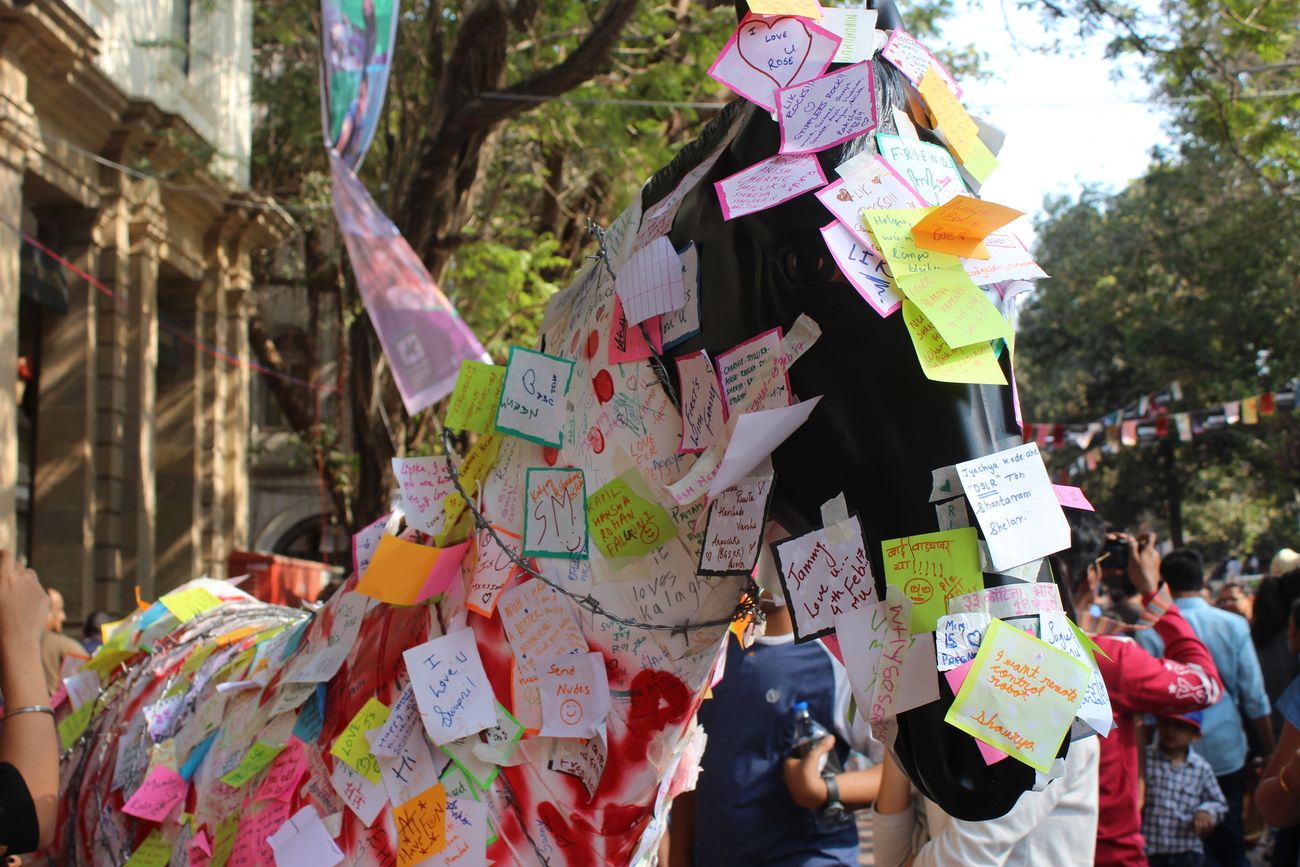 People and visitors write their messages and signatures on the colorful sticky notes and express their feelings at Kala Ghoda Arts Festival 