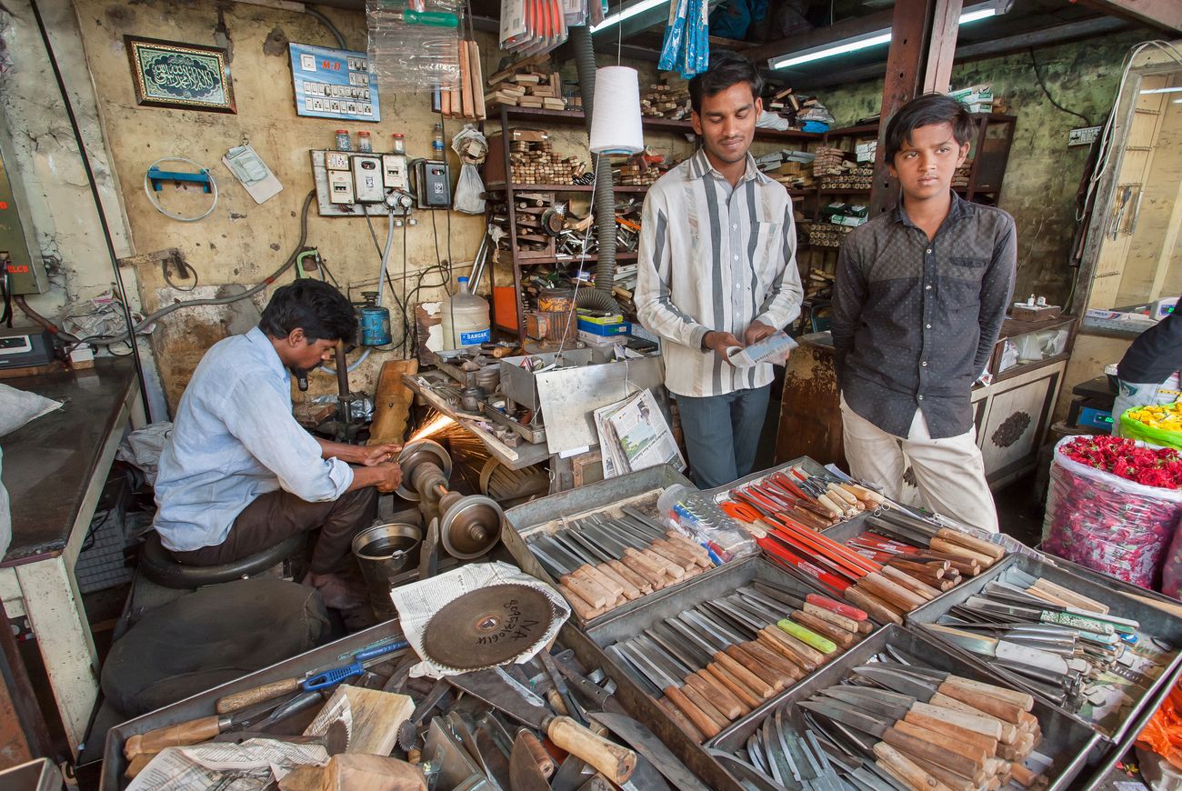 Workers of the turning shop and knife store waiting for the customers on Market Street. The Silicon Valley of India, Bangalore is the third most populous Indian city with a population of 8.52 million