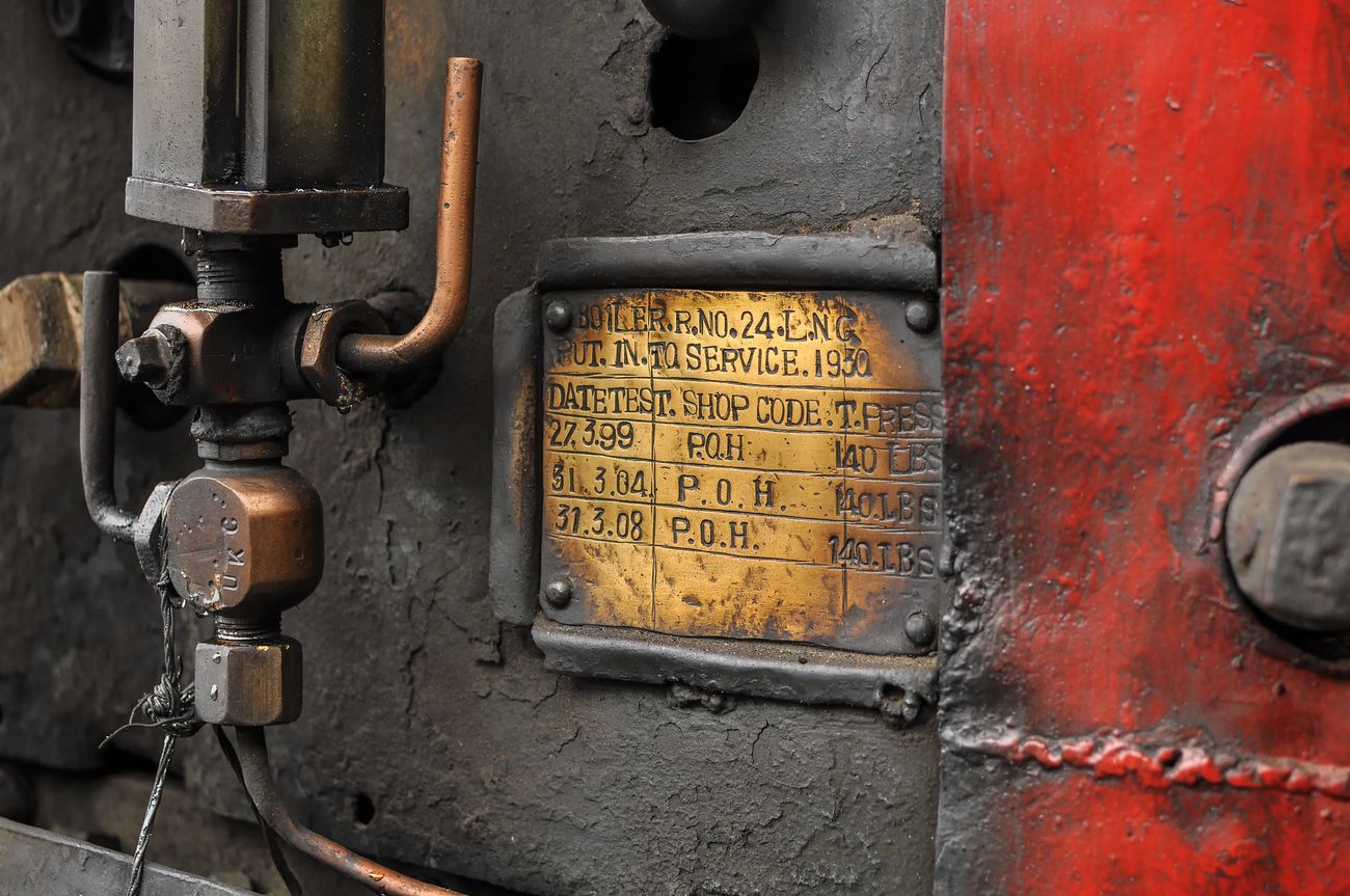 A close up shot of the information on the engine of the Toy Train with important information regarding the engine for maintenance staff 