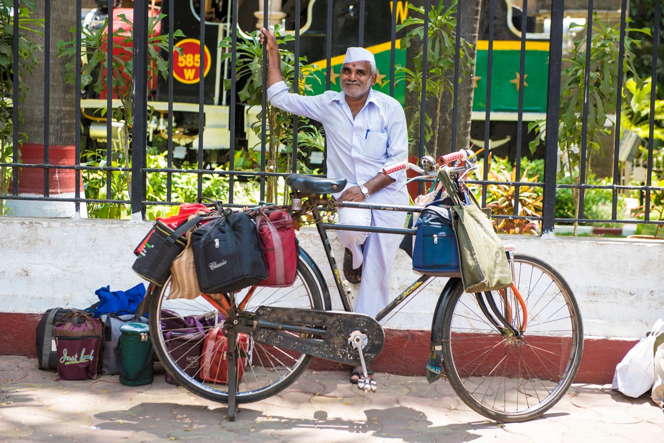 A dabbawala with his bicycle outside Churchgate Railway Station, Mumbai. Dabbawalas are a part of Mumbai's unique lunch box delivery and returns system run by an army of over 5000 men © Arun Sambhu Mishra
