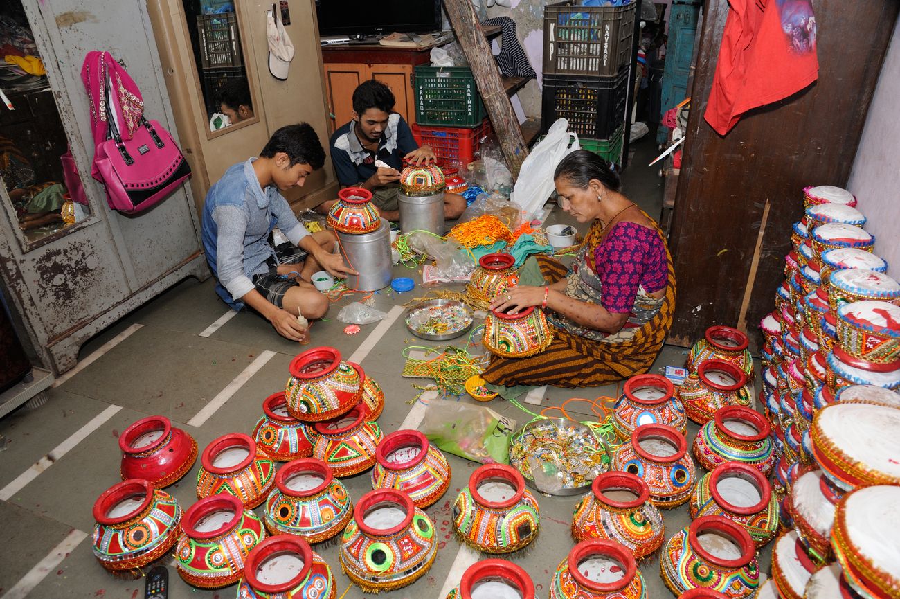 A family is painting pots for the Navratri festival, in Dharavi Mumbai. Navratri is a Gujrati festival which is celebrated with equal passion and vigor in the city