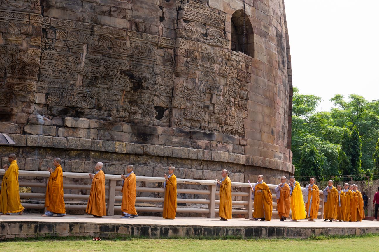 A group of Buddhist monks goes round the Dhamek Stupa in Sarnath, near Varanasi