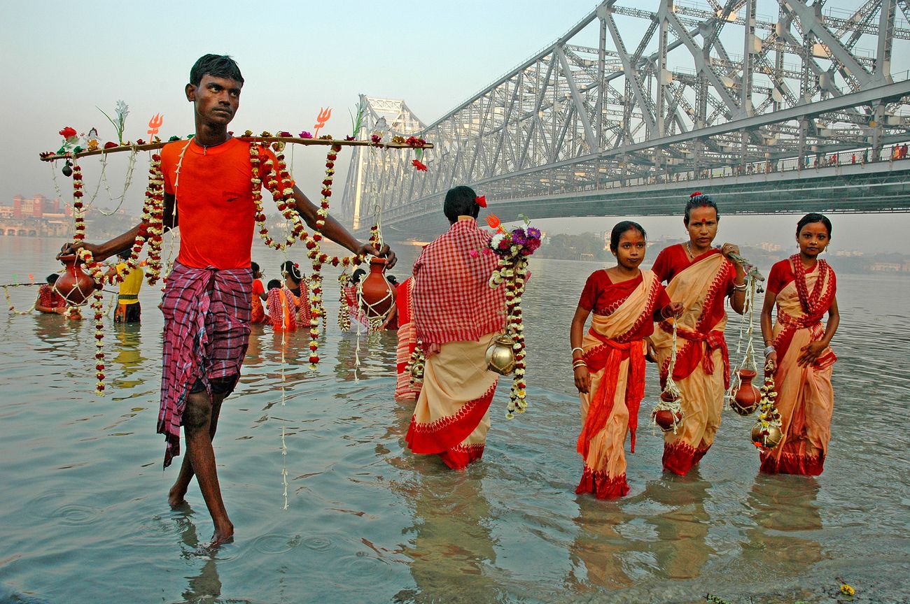 A group of devotees collecting the holy water from River Hoogly in Kolkata for offering to Lord Shiva