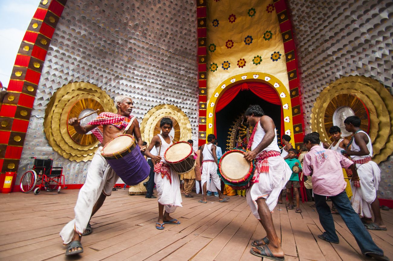 A group of Dhaakis playing dhak, a traditional musical instrument, at a Durga Puja Pandal in Kolkata, West Bengal