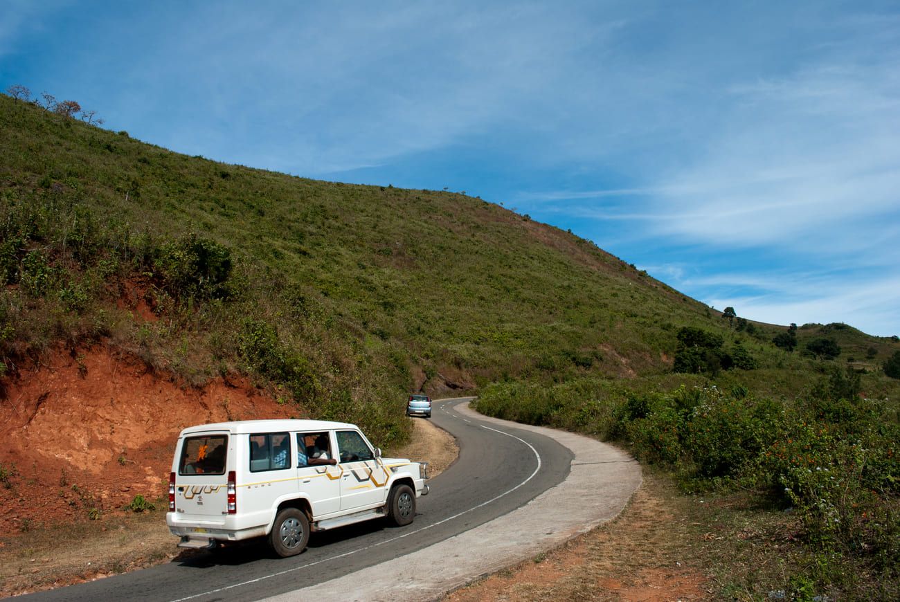 A Jeep with tourists follow the winding road around the mountains surrounding the Araku Valley in Andhra Pradesh 
