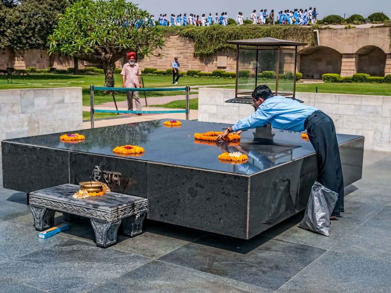 A Mahatma Gandhi admirer placing floral wreaths on the Raj Ghat memorial in his honor, New Delhi 