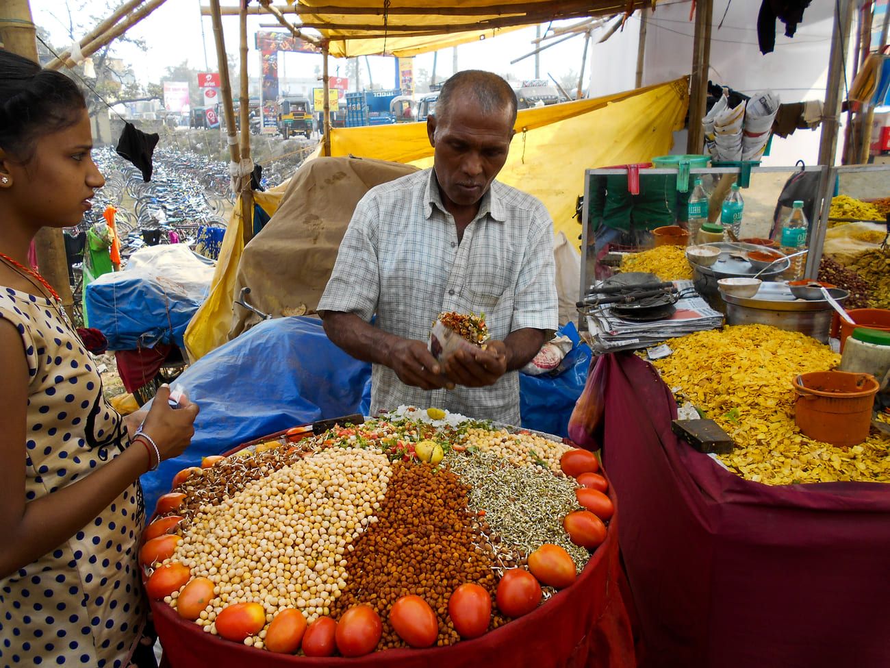 A merchant selling some of his artfully displayed snacks to a customer. Sonepur Cattle Mela takes place in November and December every year