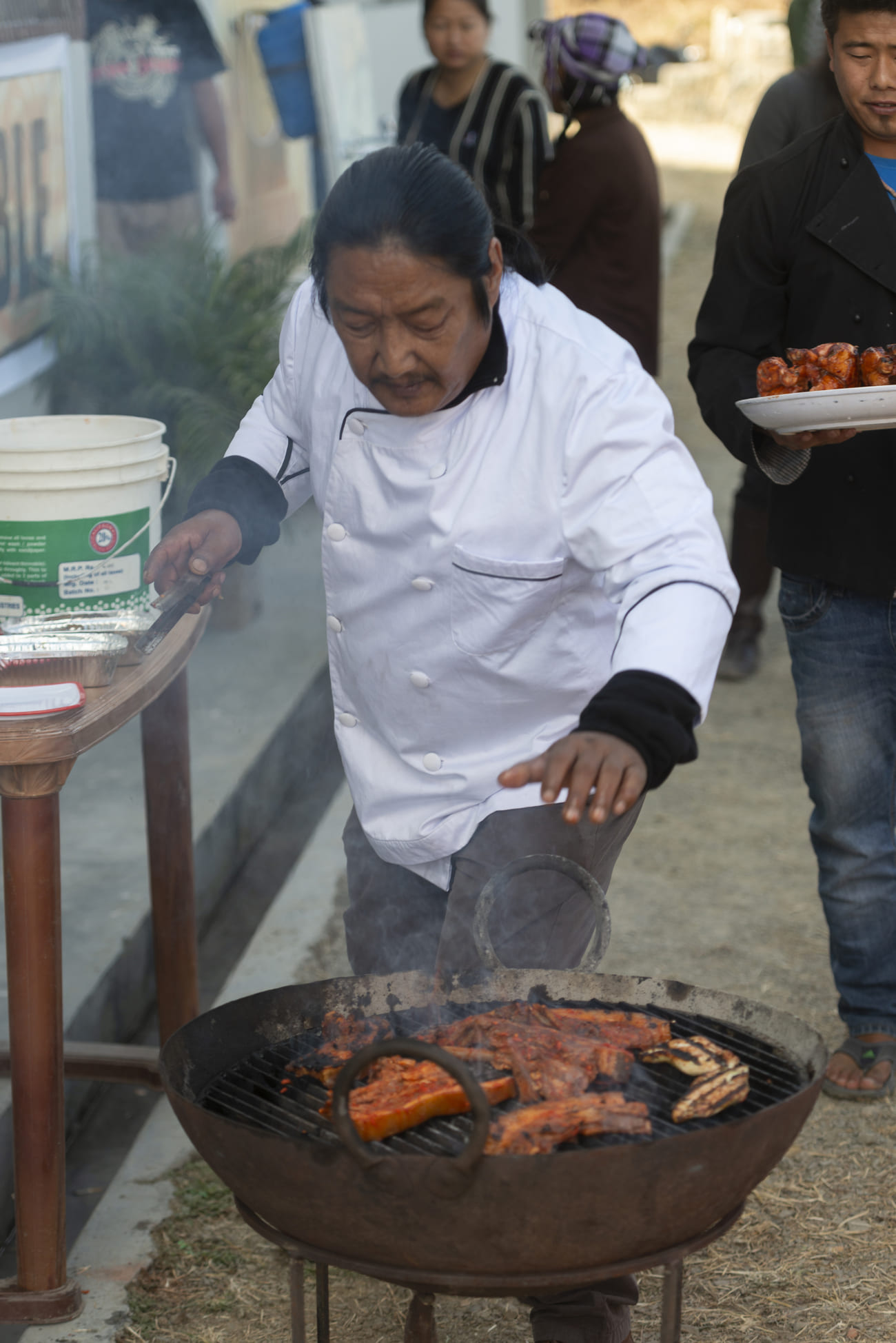 At a street food stall a Naga chef is hard at work, preparing traditional fare for the Hornbill Festival