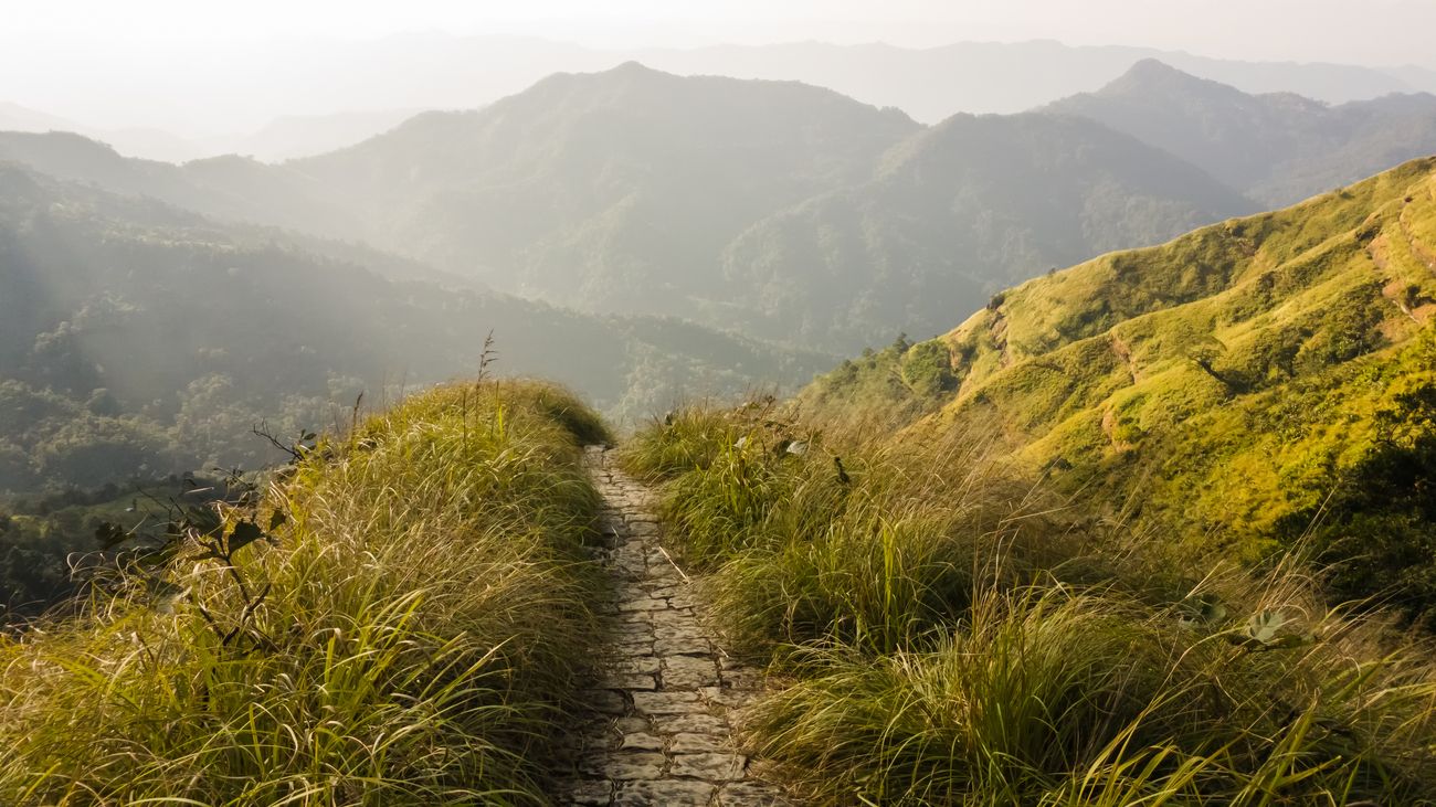 A narrow, stone-paved walkway in the mountains of Reiek near the city of Aizawl. Setting forth on hidden jungle trails is a must do experience in Mizoram 