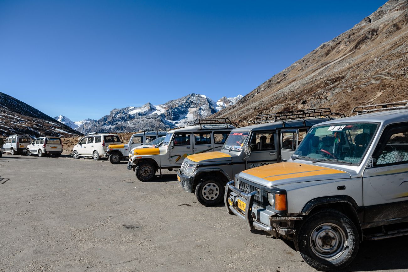 A parking spot for jeep used by visitors to get to the Zero Point at Lachung in North Sikkim, with snowclad mountains of the winter season in the back