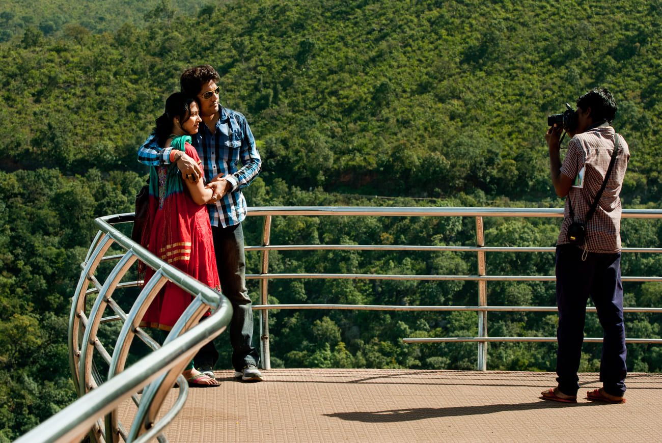A professional photographer captures a couple on film at one of the viewpoints in the Araku Valley. The town is a popular tourist attraction, famous for its waterfalls, gardens and beautiful scenery 