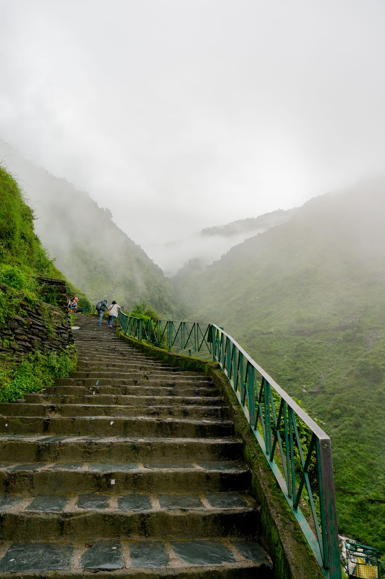 A series of stone steps disappear in the fog and mist near Bhagsu Waterfall. It forms part of the popular two-day Triund Trek 