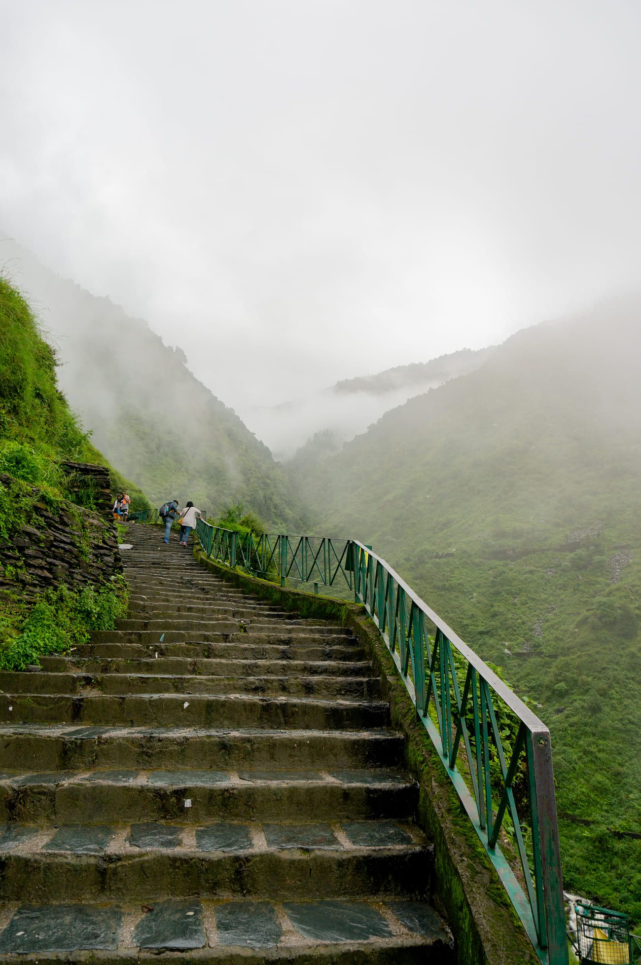 A series of stone steps disappear in the fog and mist near Bhagsu Waterfall. It forms part of the popular two-day Triund Trek
