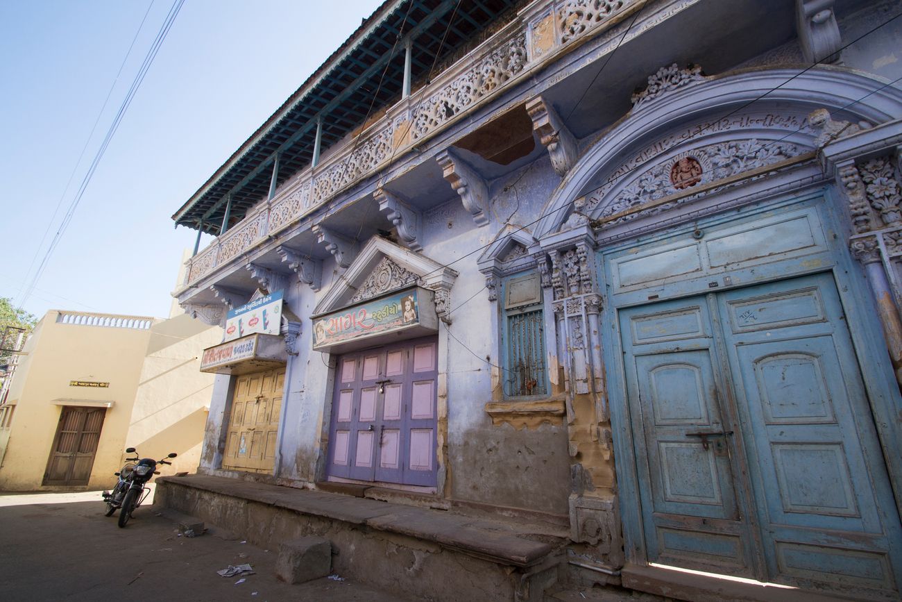 A shot of the colonial style houses in Mandvi with painted doors that were once bright but have now turned pastel with wear 