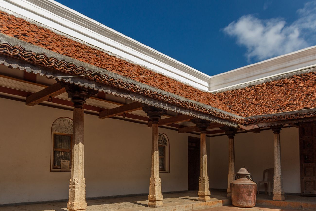 A sneak peek into the courtyard of an ancient Brahmin house, with its rusty terracotta roof tiles, in Tamil Nadu