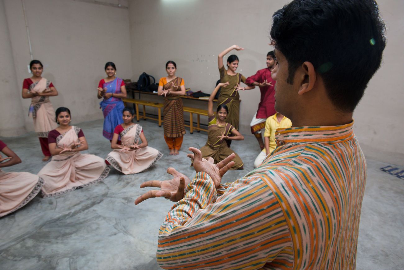 A teacher demonstrates hand movements to a class of students learning the Mohiniyattam dance form at RLV College of Music and fine arts in Ernakulam, India.