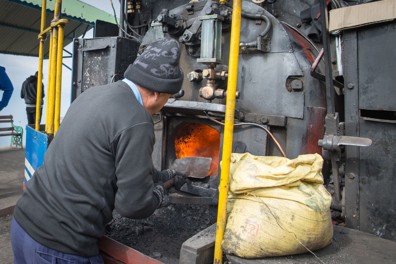 A technician services the steam generating valve of the engine that runs the Darjeeling Himalayan Railway Toy Train, one of the most popular joy rides in the entire world