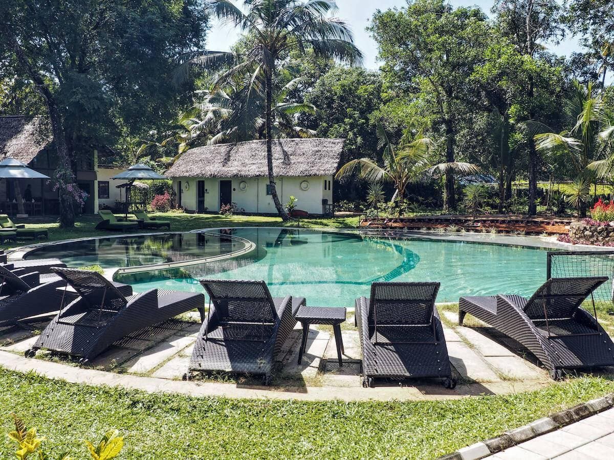 A tranquil scene with sunbeds round a crystal clear pool at the Xandari Pearl Resort.