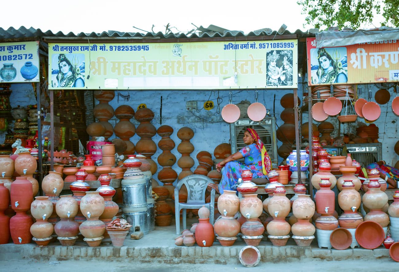 A vendor at her stall selling water vessels 