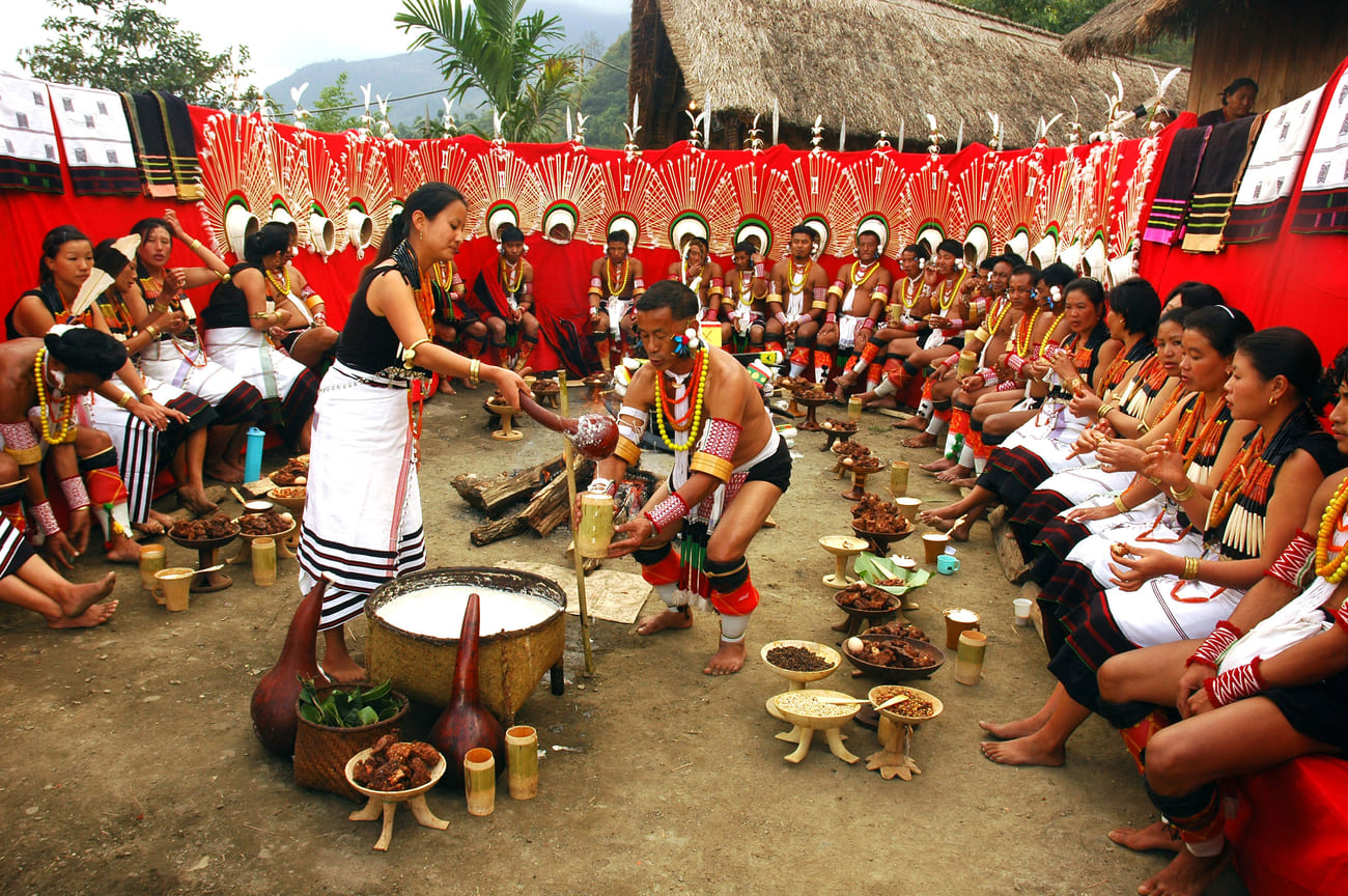 A woman serving a member of her tribe during a traditional celebratory feast 