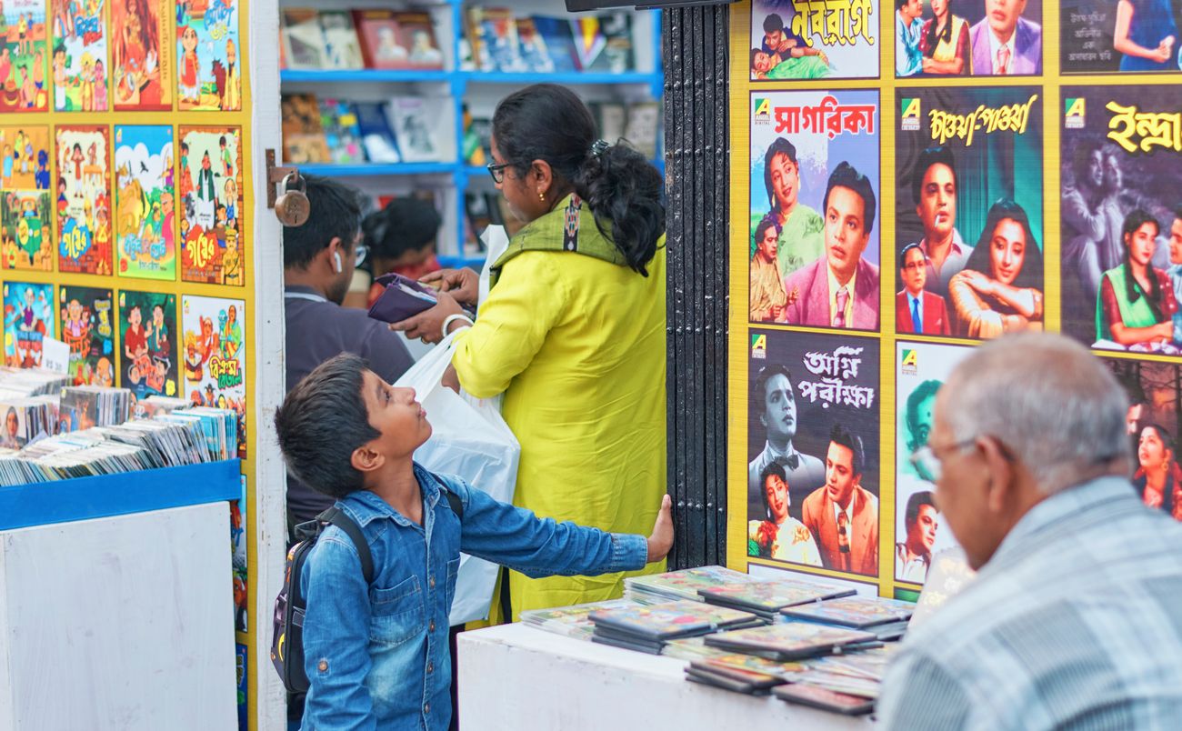 A young boy looking at the posters of retro Bengali movies which starred the iconic Uttam Kumar 
