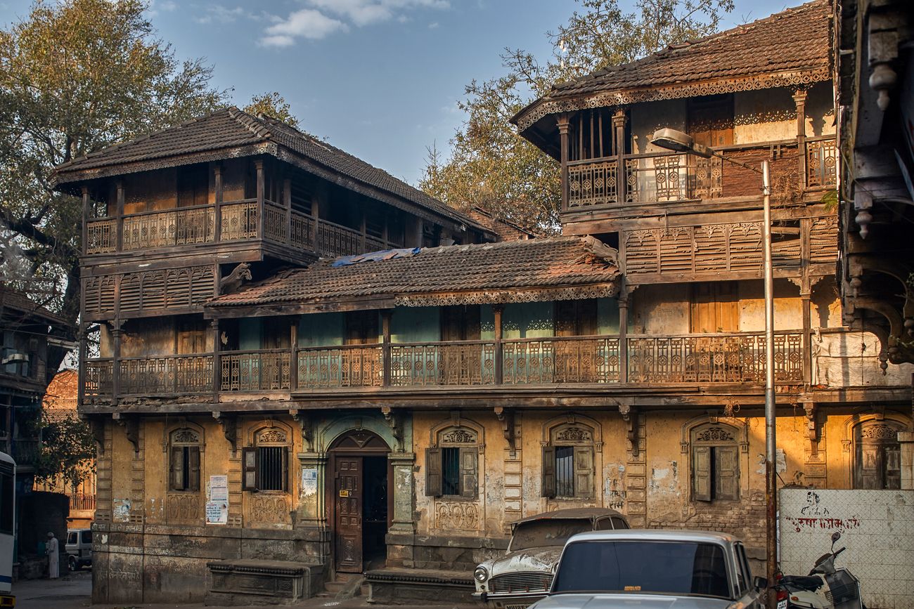 An old two story house with beautiful lattice work balconies in Nashik