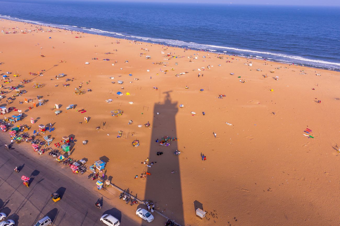 An eye-catching, birds’ eye picture of the lighthouse’s shadow falling on Marina Beach in the late afternoon