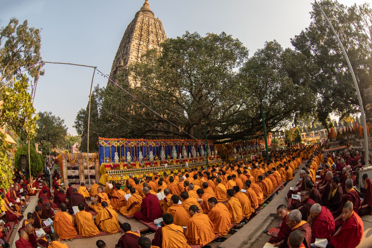 Buddhist monks sit on the ground to chant and offer prayers at the MahaBodhi Temple Complex in Bodh Gaya