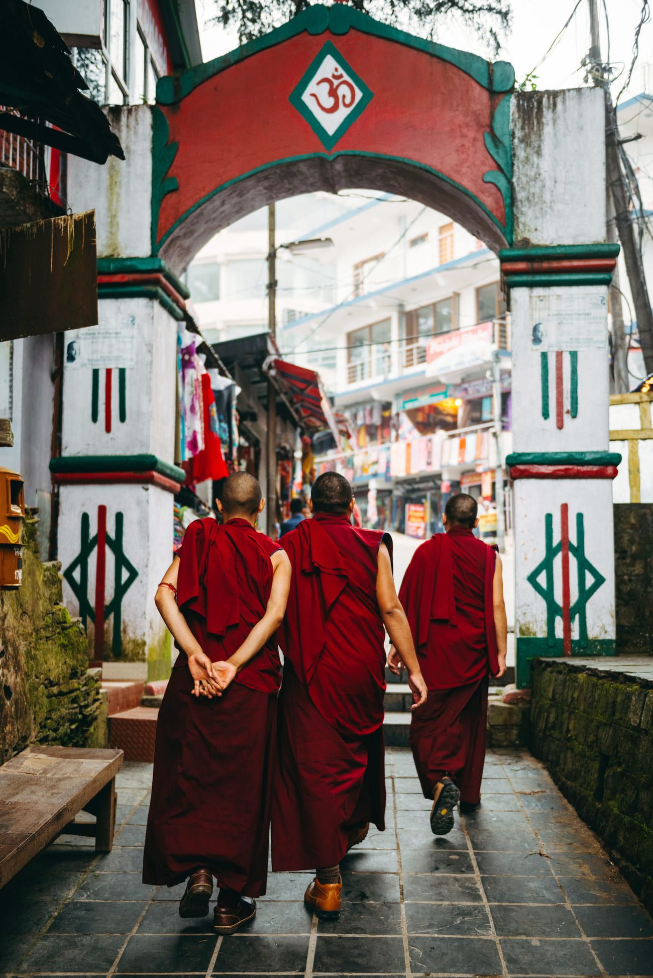 Buddhist monks walking along a picturesque street in Bhagsu