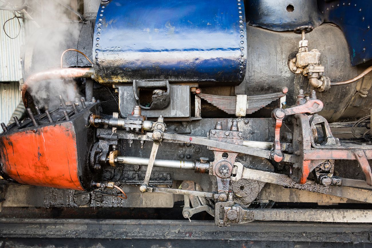 An upclose shot of the steam cylinder and the valves of the engine that runs the beloved Darjeeling Toy Train 