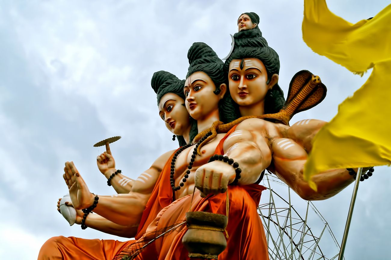 Colorful close-up of trimurti, the three-headed image of the main deities of Hinduism; Shiva, Vishnu and Brahma