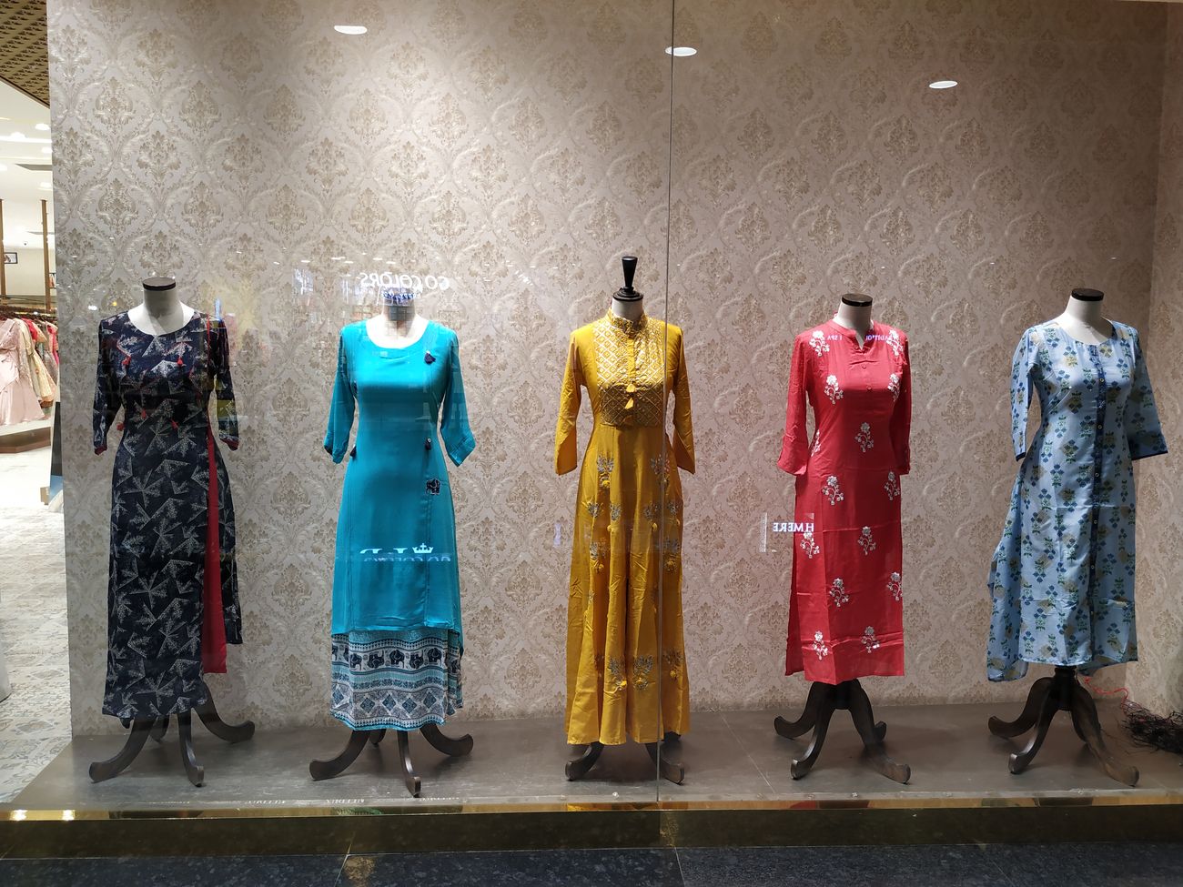 Colorful dresses in the window of a clothes store in Phoenix Market City lure customers inside