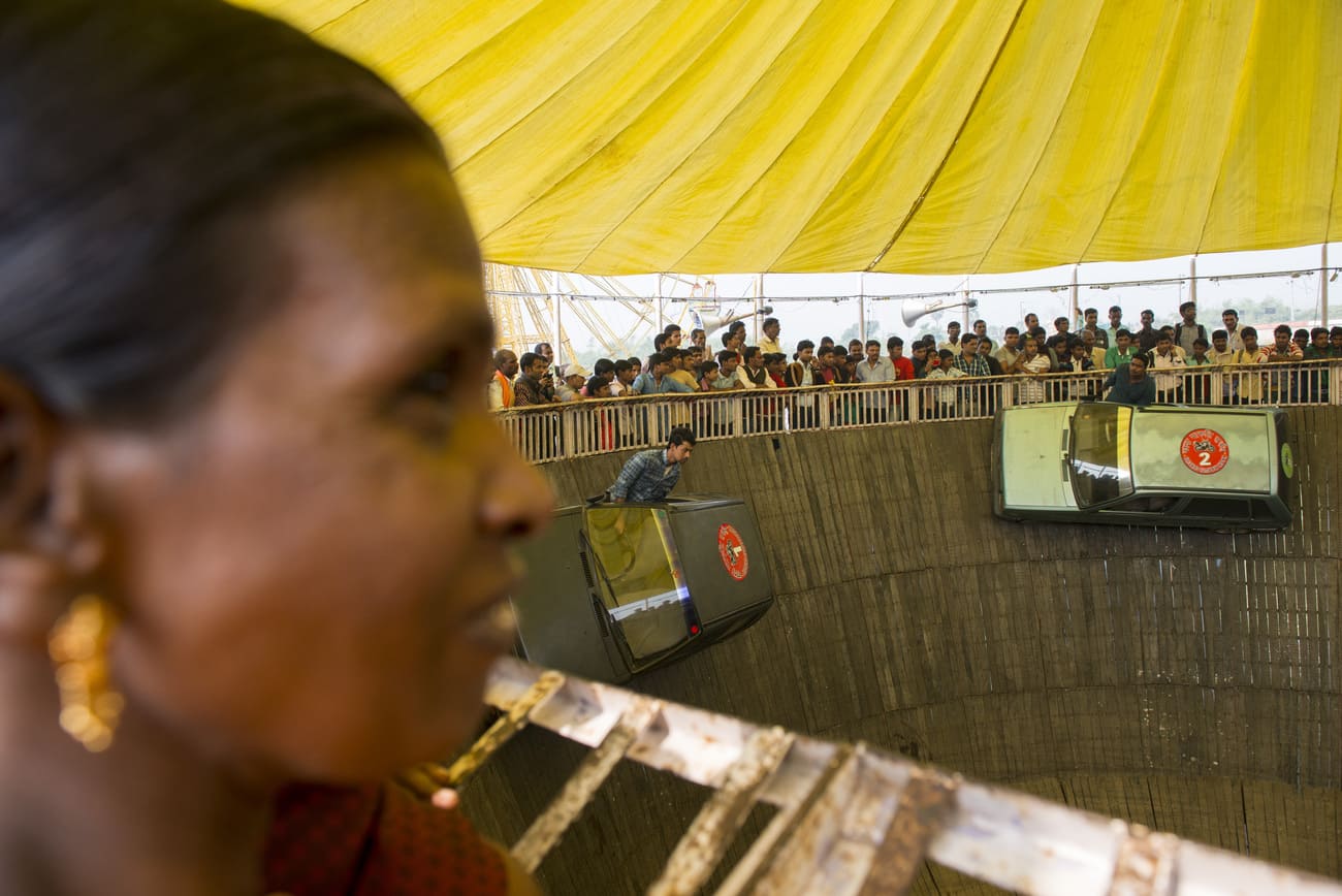 Curious onlookers watch the stunts of acrobats in the Well of Death, or Maut ka Kuan. These shows are extremely popular and draw large crowds every year