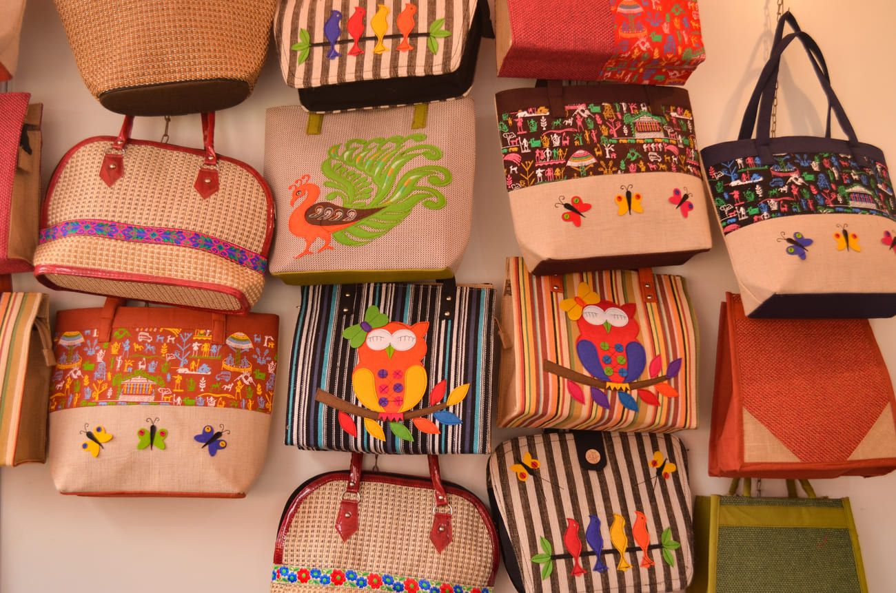 In Dilli Haat the visitor will find a huge selection of artifacts and handiwork from every corner of the country. Designer jute tote bags on display at a handicraft exhibition at a shop in Dilli Haat, New Delhi, India