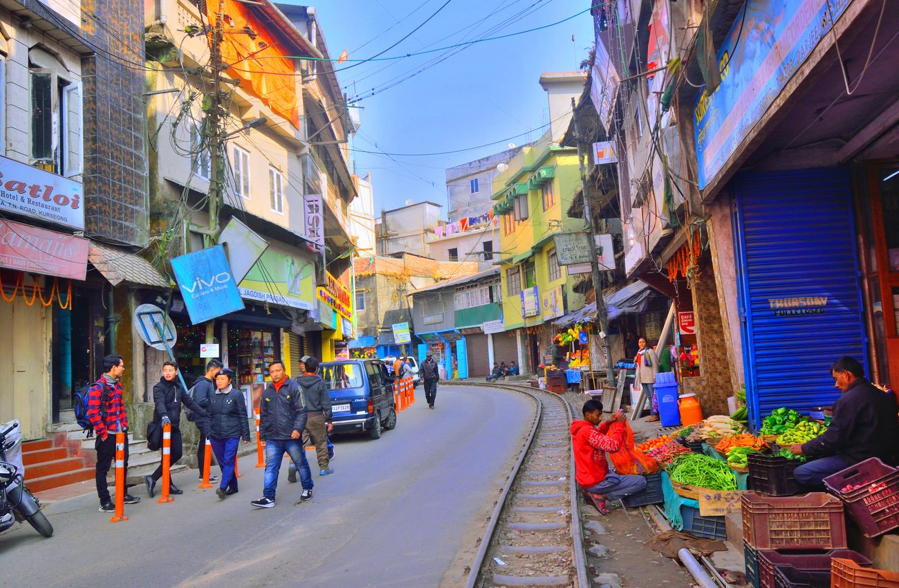 Early morning at a narrow street in Darjeeling as vegetable shops open up and locals dressed for the weather set out for work 