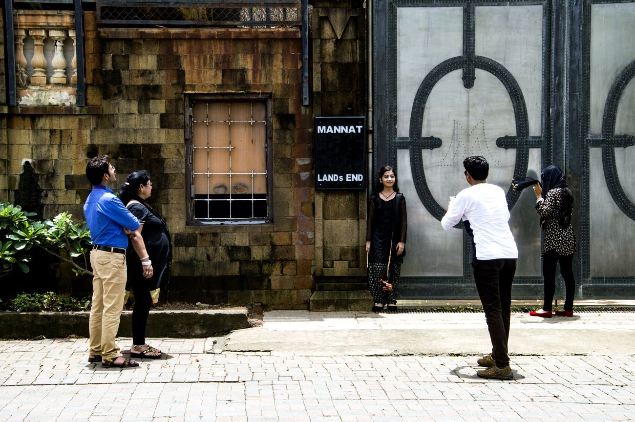 Fans of Bollywood Star Shah Rukh Khan click pictures outside his villa named Mannat in the Bandra area of Mumbai