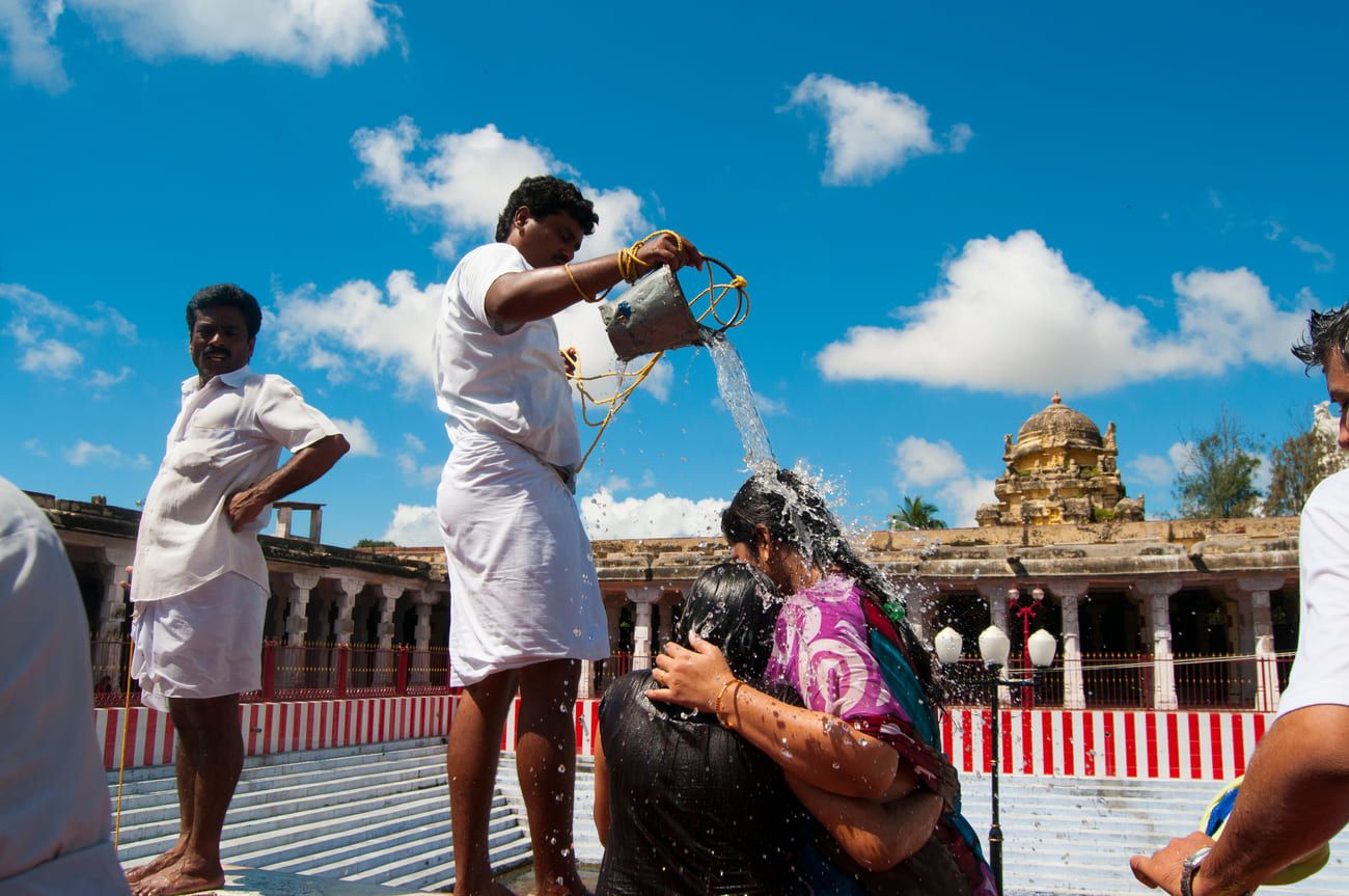 Hindu pilgrims at one of the twenty-two water tanks at Ramanathaswamy Temple. Bathing in one of these sacred tanks is considered an act of penance