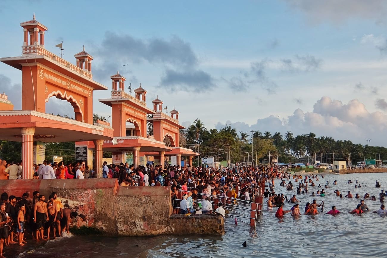 Hundreds of devotees bathe themselves in the Arabian Sea before entering the temple grounds 
