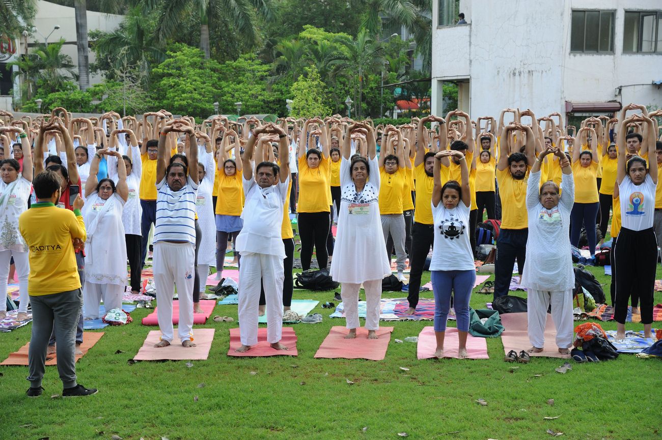 International Yoga Day celebrations in progress at a residential complex as residents perform yoga poses and stretches