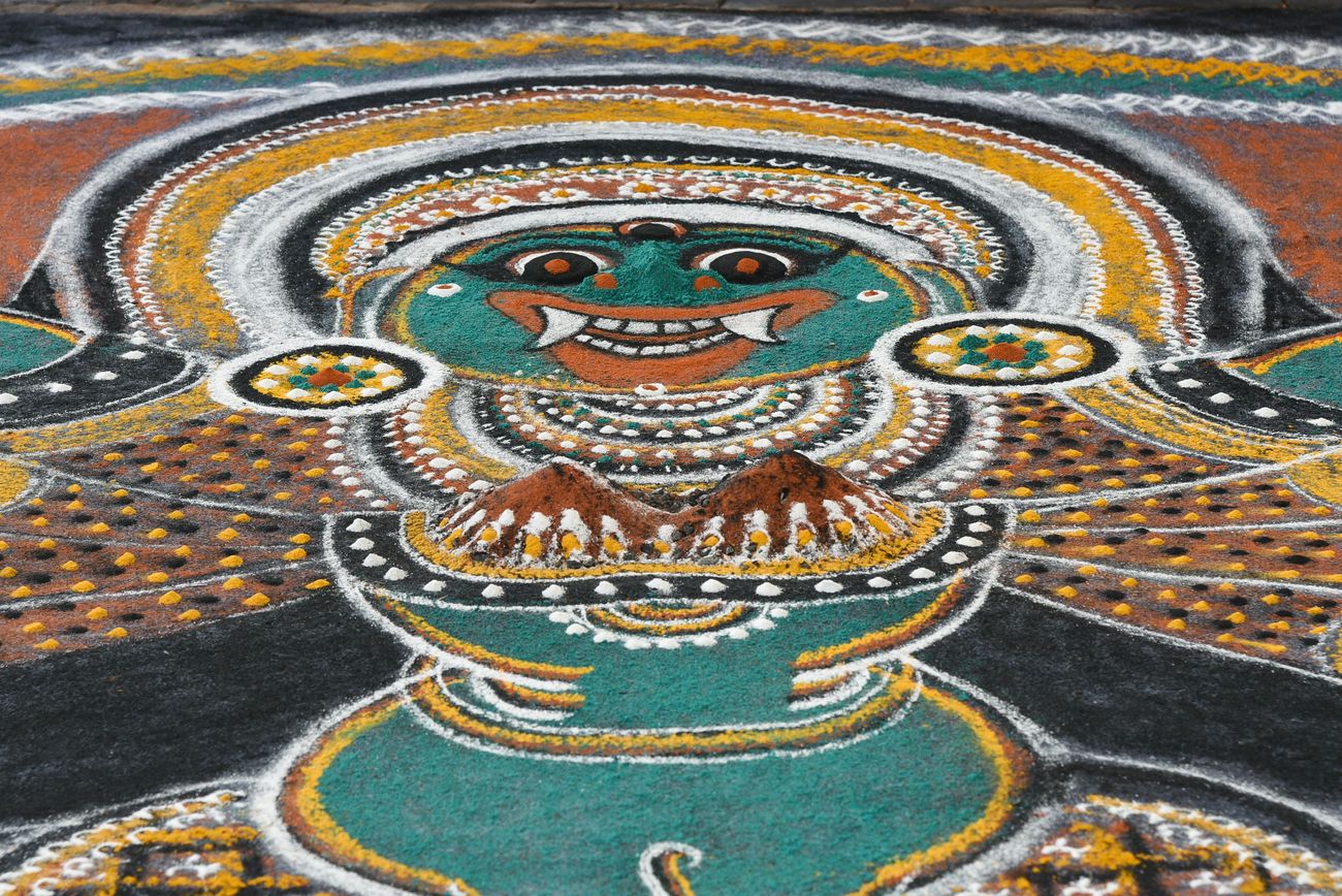 Kolam, also known as dhulee chithram and referred to rangoli in the North of India, in Wayanad, uses colored powders on the floor as a canvas to celebrate, worship and propitiate goddess Kaali