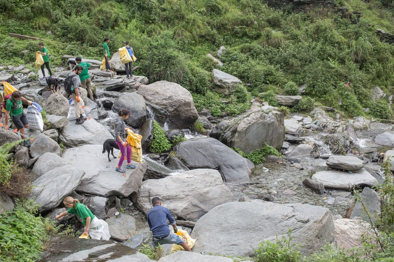 Members of the Waste Warriors NGO clean the area near Bhagsu’s famous waterfall