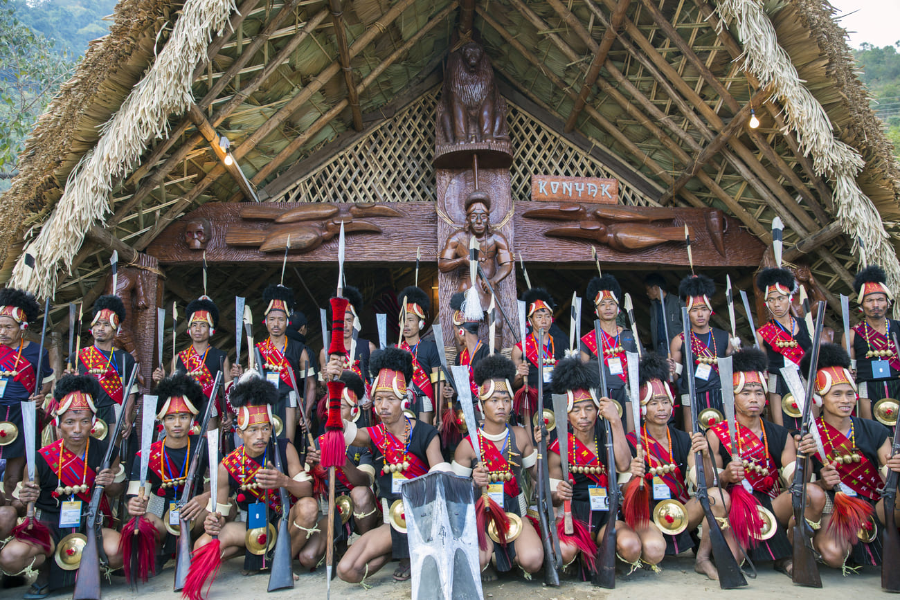 Naga tribesmen in traditional dress pose for a photo at the Hornbill Festival. This event features a wide spectrum of Nagaland arts and crafts, like bone and bead jewelry, shawls sporting animal patterns, bamboo ware, and black pottery. Especially interesting are the manufactures of traditional hunting implements, such as spears and knives