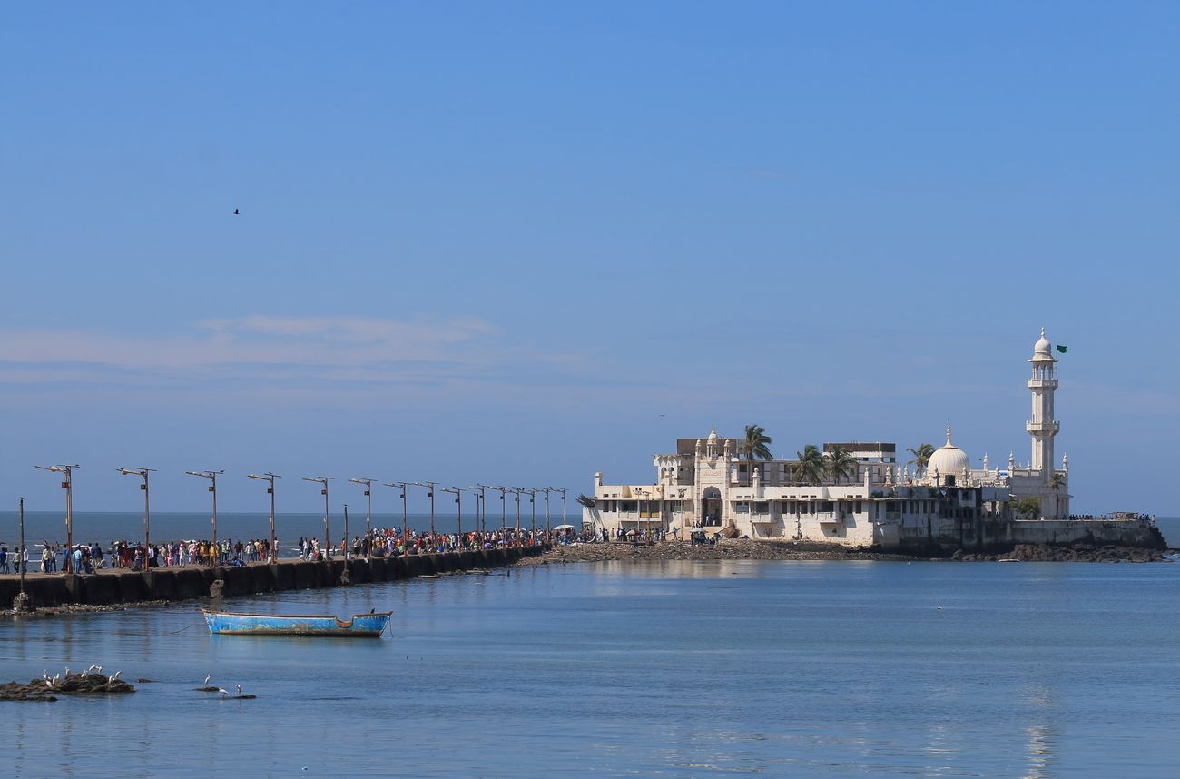 One of Mumbai's most prominent landmarks, the Haji Ali Dargah (Mosque) is situated in the middle of the sea and is named after Pir Haji Ali Shah Bukhari, one of the greatest Muslim saints of his time. Built on a tiny islet located 500 yards in the middle of Worli Bay, the dargah can be visited only during low tide